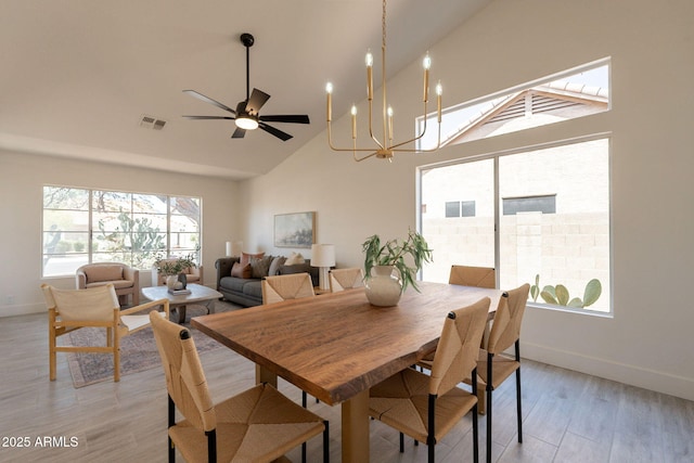 4037 E Milton Dr, Cave Creek, AZ 85331 - dining room with high vaulted ceiling, light wood-style flooring, a chandelier, and a ceiling fan