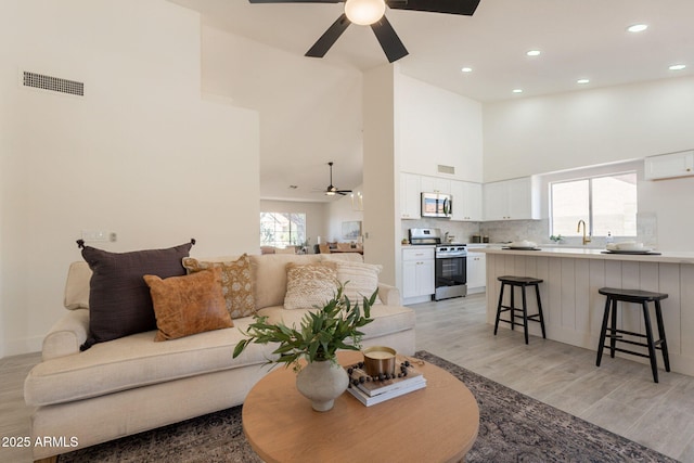 4037 E Milton Dr, Cave Creek, AZ 85331 - living area with a ceiling fan, a towering ceiling, light wood-type flooring, and recessed lighting