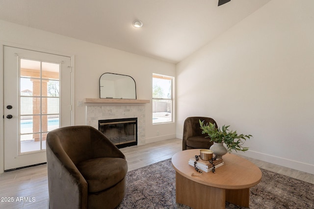 4037 E Milton Dr, Cave Creek, AZ 85331 - living area featuring a fireplace, light wood-style floors, vaulted ceiling, and a ceiling fan