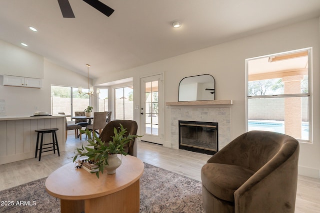4037 E Milton Dr, Cave Creek, AZ 85331 - living room with ceiling fan, healthy amount of natural light, light wood-style flooring, a tiled fireplace, and lofted ceiling