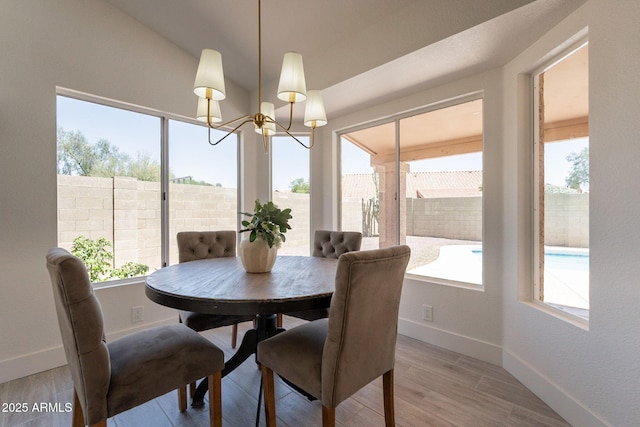 4037 E Milton Dr, Cave Creek, AZ 85331 - dining room featuring a chandelier, plenty of natural light, and light wood-style flooring