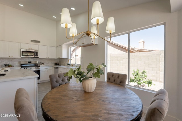 4037 E Milton Dr, Cave Creek, AZ 85331 - dining room with a towering ceiling, recessed lighting, and a chandelier