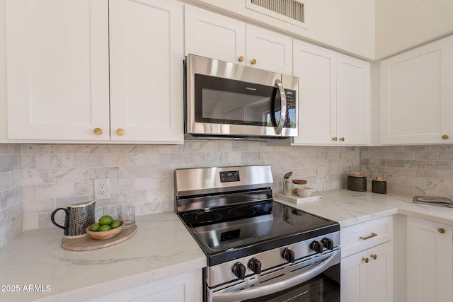 4037 E Milton Dr, Cave Creek, AZ 85331 - kitchen featuring appliances with stainless steel finishes, white cabinetry, and decorative backsplash