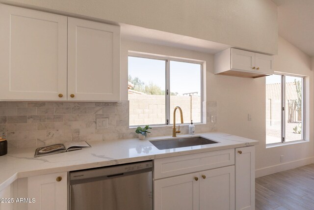 4037 E Milton Dr, Cave Creek, AZ 85331 - kitchen with stainless steel dishwasher, decorative backsplash, white cabinetry, light wood finished floors, and light stone countertops