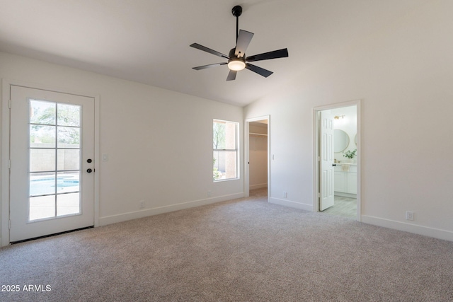 4037 E Milton Dr, Cave Creek, AZ 85331 - unfurnished bedroom with light carpet, vaulted ceiling, ensuite bathroom, a walk in closet, and ceiling fan