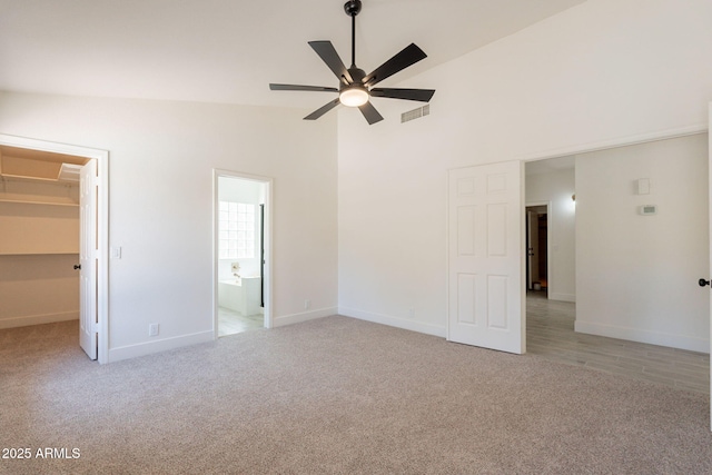 4037 E Milton Dr, Cave Creek, AZ 85331 - unfurnished bedroom with light colored carpet, a spacious closet, attic access, high vaulted ceiling, and connected bathroom