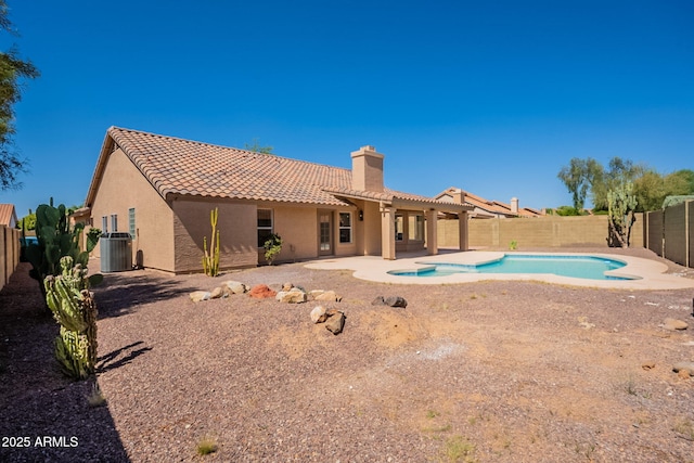 4037 E Milton Dr, Cave Creek, AZ 85331 - rear view of house featuring a tiled roof, stucco siding, a fenced backyard, and a chimney