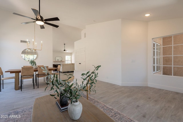 4037 E Milton Dr, Cave Creek, AZ 85331 - dining space with a ceiling fan, high vaulted ceiling, wood finished floors, a chandelier, and recessed lighting