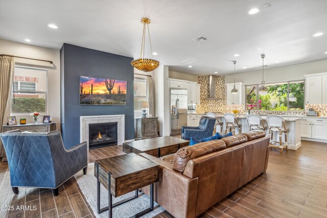 625 W Echo Ln, Phoenix, AZ 85021 - living area featuring dark wood-type flooring, visible vents, a glass covered fireplace, and recessed lighting
