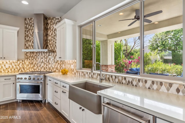 625 W Echo Ln, Phoenix, AZ 85021 - kitchen with stainless steel appliances, light countertops, wall chimney range hood, white cabinets, and a sink
