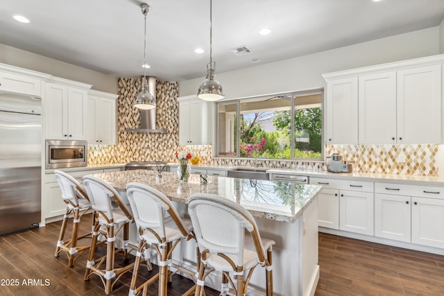 625 W Echo Ln, Phoenix, AZ 85021 - kitchen featuring built in appliances, visible vents, white cabinetry, and a kitchen island