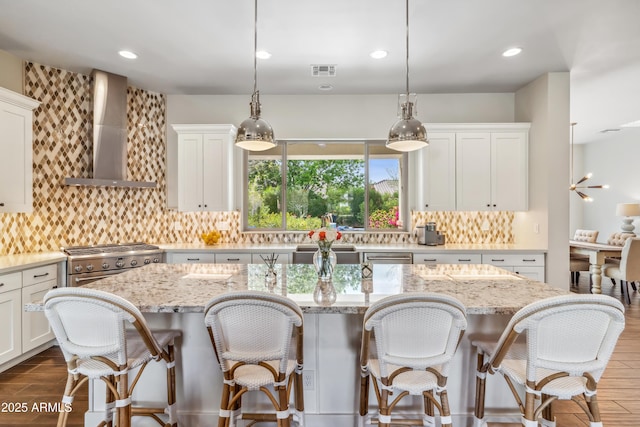625 W Echo Ln, Phoenix, AZ 85021 - kitchen with wall chimney range hood, visible vents, dark wood-style floors, a center island, and backsplash