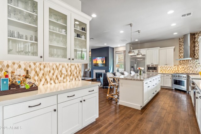 625 W Echo Ln, Phoenix, AZ 85021 - kitchen with built in appliances, tasteful backsplash, visible vents, white cabinetry, and wall chimney range hood