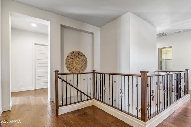 625 W Echo Ln, Phoenix, AZ 85021 - hallway with baseboards, visible vents, wood finished floors, and an upstairs landing