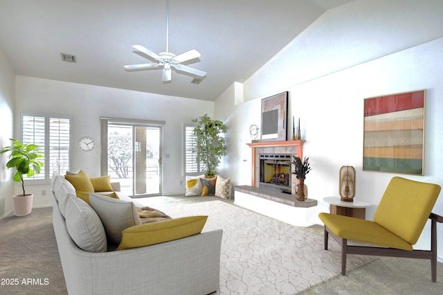 living room featuring lofted ceiling, ceiling fan, and carpet