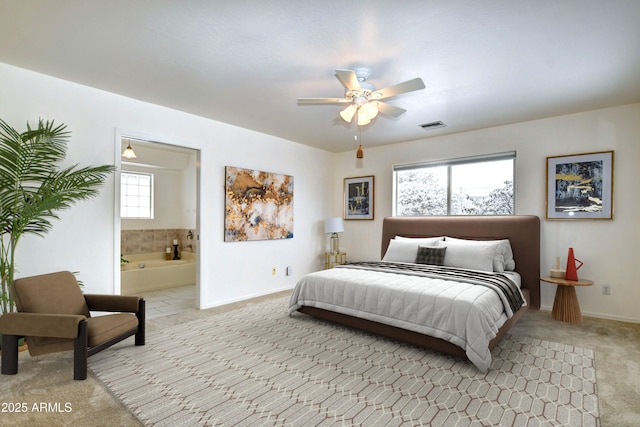 carpeted bedroom featuring ensuite bath