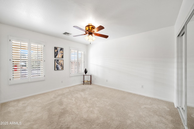 unfurnished bedroom with ceiling fan, a closet, and light carpet