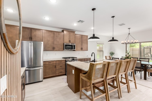 8640 W Frier Dr, Glendale, AZ 85305 - kitchen featuring appliances with stainless steel finishes, a sink, tasteful backsplash, plenty of natural light, and recessed lighting