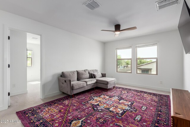 8640 W Frier Dr, Glendale, AZ 85305 - carpeted living room featuring ceiling fan and baseboards