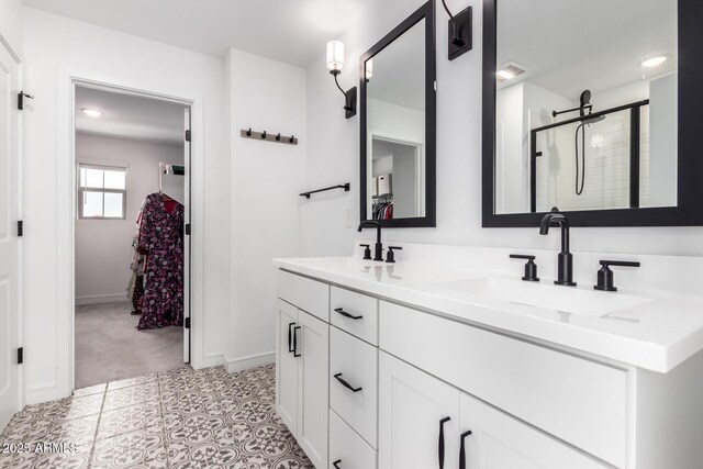 8640 W Frier Dr, Glendale, AZ 85305 - bathroom featuring double vanity, tiled shower, and baseboards