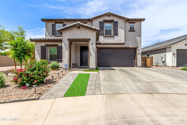 8640 W Frier Dr, Glendale, AZ 85305 - view of front of house with stucco siding, driveway, and a tile roof