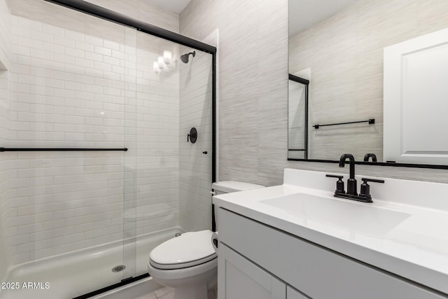 8640 W Frier Dr, Glendale, AZ 85305 - full bath featuring toilet, vanity, a shower stall, and tile walls