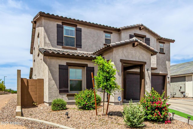 8640 W Frier Dr, Glendale, AZ 85305 - view of front of house with a tile roof, stucco siding, and an attached garage