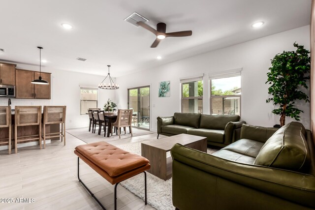 8640 W Frier Dr, Glendale, AZ 85305 - living room featuring ceiling fan, recessed lighting, and a chandelier