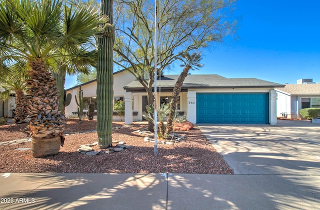 view of front of property with stucco siding, driveway, and a garage