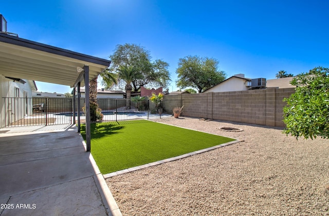 view of yard featuring a fenced in pool, a fenced backyard, a patio area, and cooling unit
