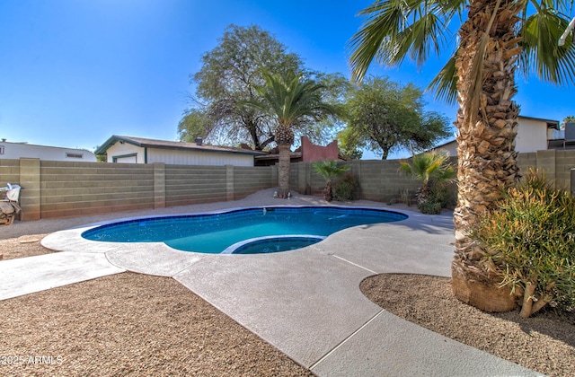 view of swimming pool with a fenced backyard, a pool with connected hot tub, and a patio area