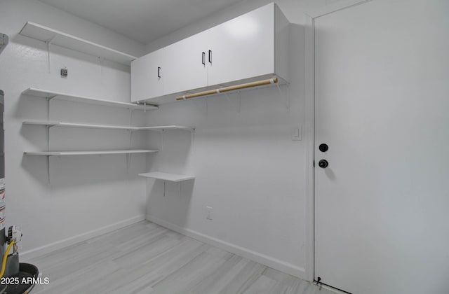 washroom featuring baseboards and light wood-style flooring