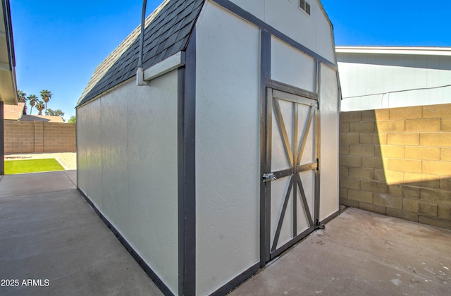 view of shed with a fenced backyard