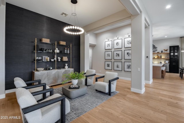 interior space featuring light wood-type flooring, visible vents, recessed lighting, baseboards, and an accent wall