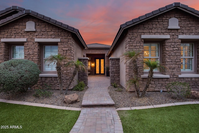 entrance to property with stone siding