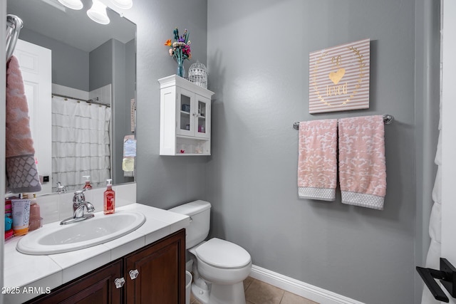 bathroom with a shower with curtain, toilet, tile patterned flooring, baseboards, and vanity