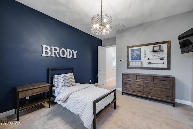 carpeted bedroom featuring a notable chandelier, visible vents, an accent wall, and baseboards