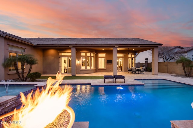 view of swimming pool with a patio area, a fenced in pool, an outdoor fire pit, and fence