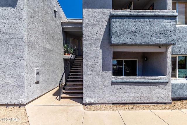 view of exterior entry with stucco siding