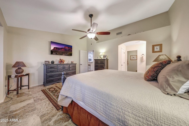 11047 W Irma Ln, Peoria, AZ 85373 - bedroom with arched walkways, baseboards, and a ceiling fan