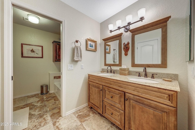 11047 W Irma Ln, Peoria, AZ 85373 - bathroom with a washtub, baseboards, double vanity, and a sink