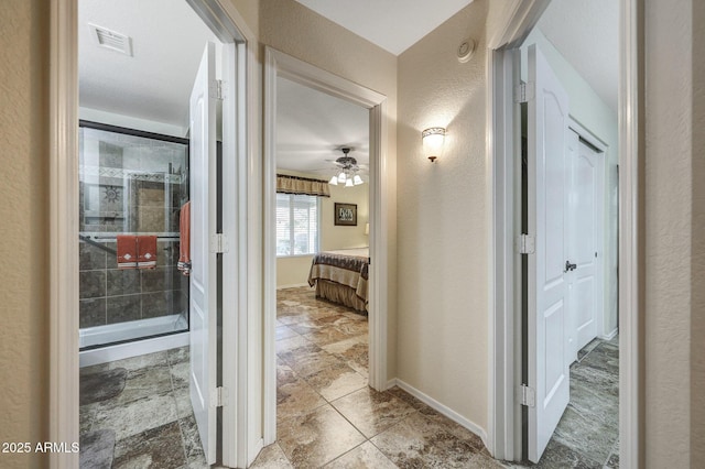 11047 W Irma Ln, Peoria, AZ 85373 - hallway featuring a textured wall, baseboards, and visible vents
