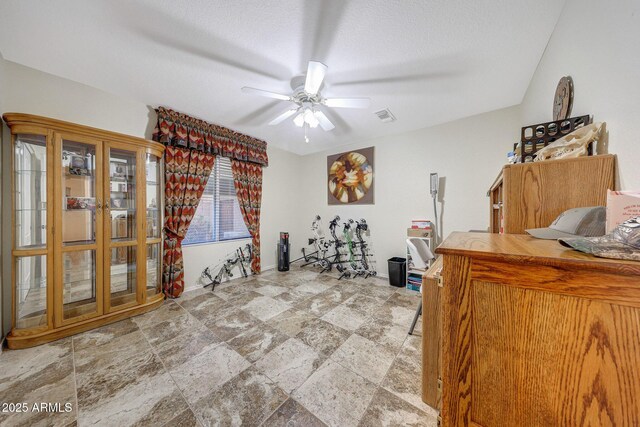 11047 W Irma Ln, Peoria, AZ 85373 - interior space featuring a textured ceiling, ceiling fan, visible vents, and stone finish flooring