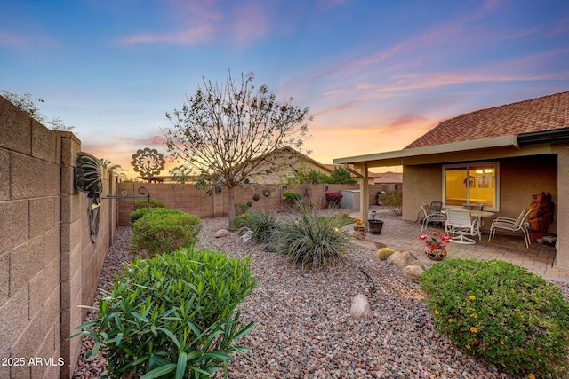 11047 W Irma Ln, Peoria, AZ 85373 - yard at dusk with a fenced backyard and a patio