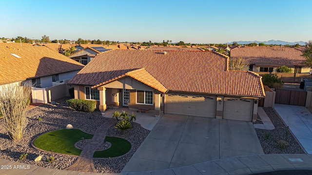 11047 W Irma Ln, Peoria, AZ 85373 - view of front of home with concrete driveway, stucco siding, fence, an attached garage, and a tiled roof