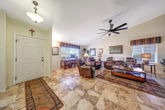 11047 W Irma Ln, Peoria, AZ 85373 - living room with a ceiling fan, stone finish floor, baseboards, and lofted ceiling