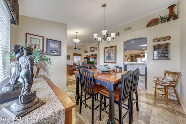 11047 W Irma Ln, Peoria, AZ 85373 - dining space with ceiling fan with notable chandelier, visible vents, stone finish flooring, and baseboards