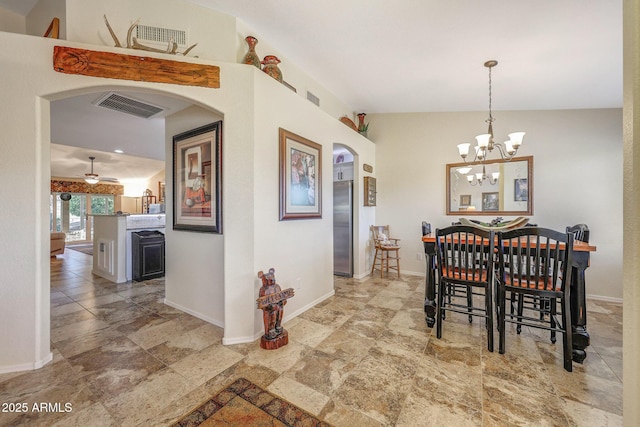 11047 W Irma Ln, Peoria, AZ 85373 - dining space with baseboards, visible vents, arched walkways, and stone finish flooring