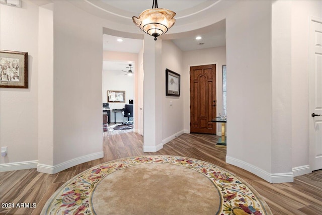 entryway with baseboards, wood finished floors, and recessed lighting