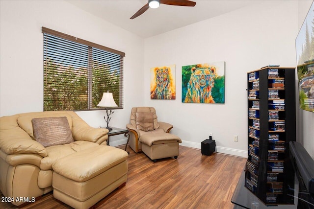 sitting room featuring ceiling fan, baseboards, and wood finished floors